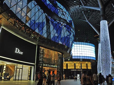 Large open mall with designer brands, including Gucci.